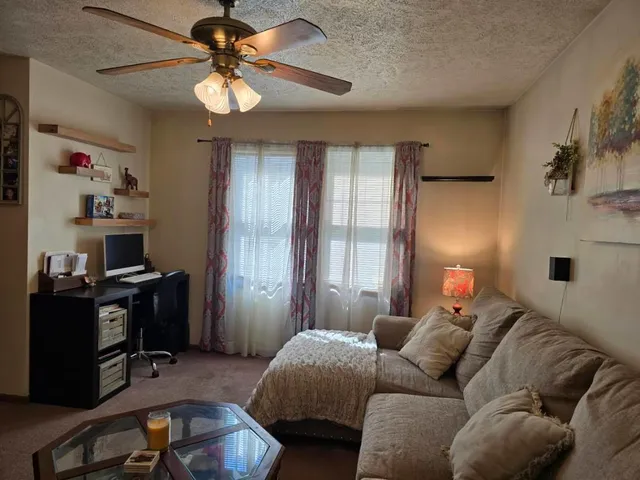 a bedroom with furniture and a chandelier