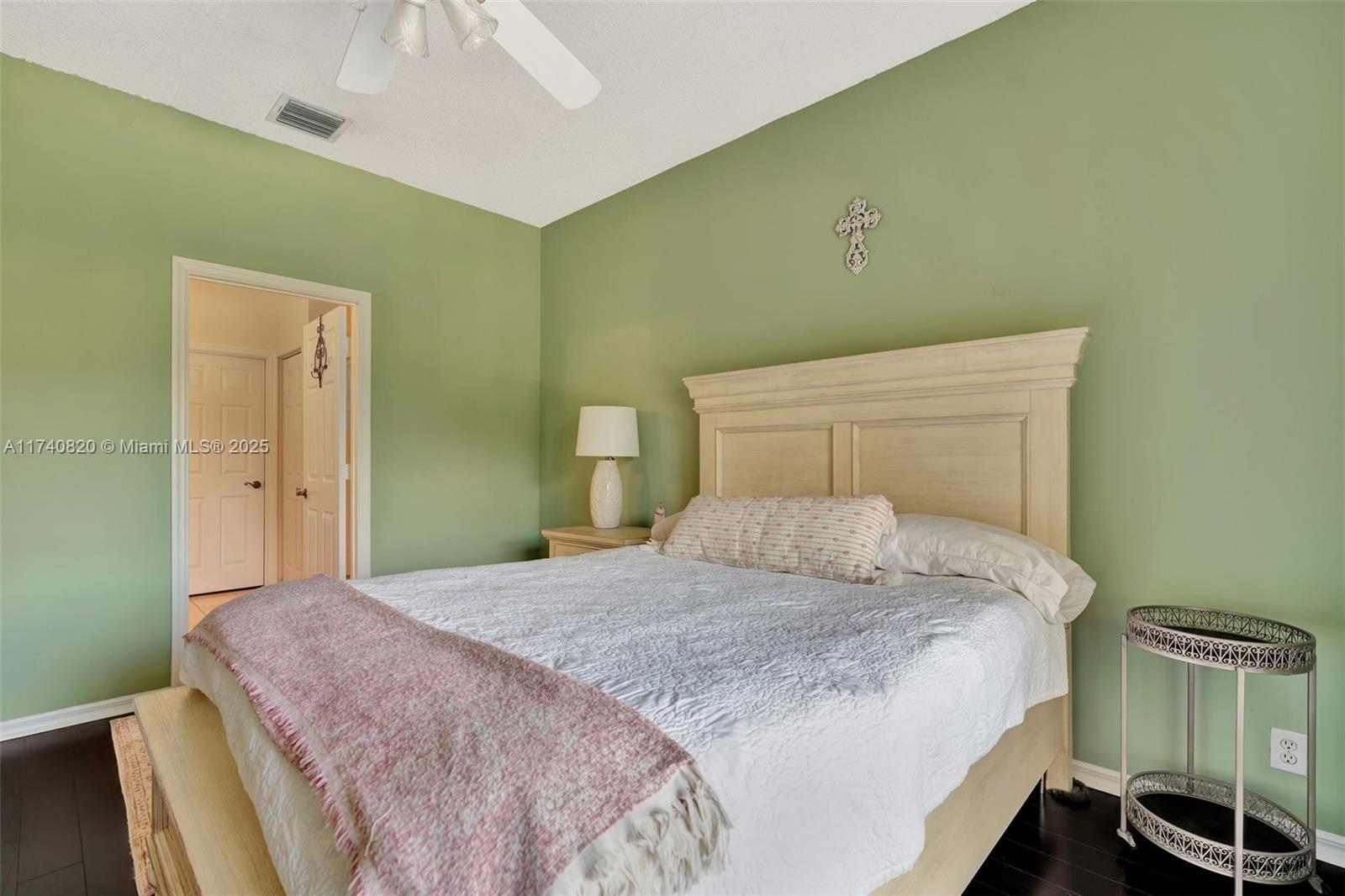 112 Lighthouse Circle, Unit H Tequesta, FL 33469 - Photo 15 of 39 a bedroom with a bed and a potted plant