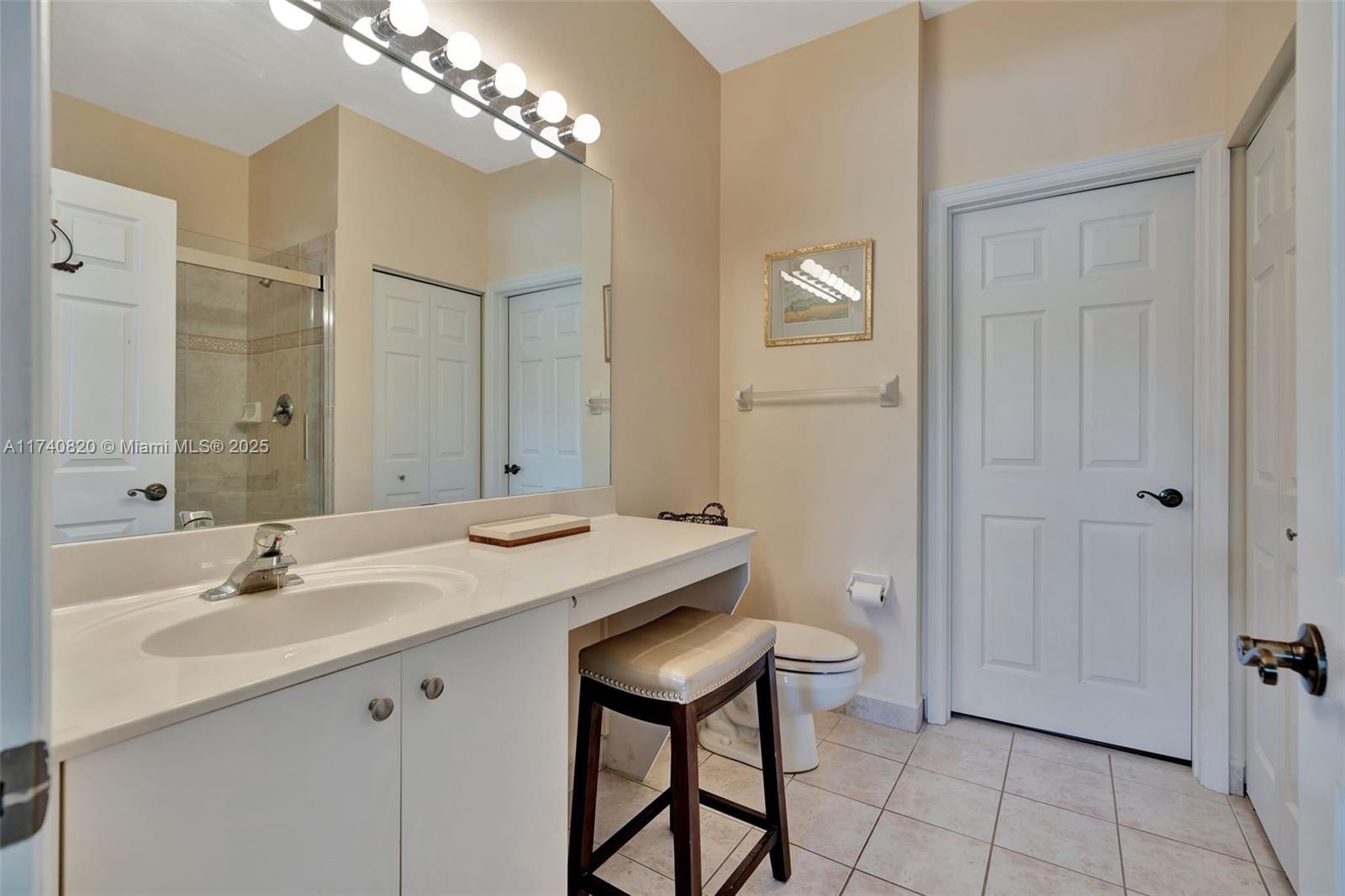 112 Lighthouse Circle, Unit H Tequesta, FL 33469 - Photo 16 of 39 a bathroom with a sink vanity and a mirror