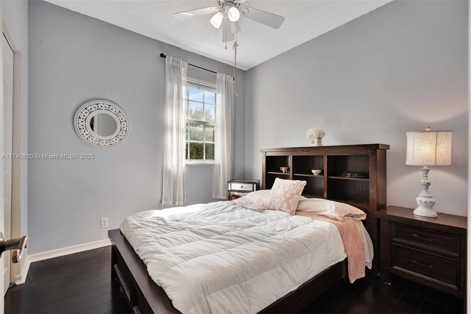 112 Lighthouse Circle, Unit H Tequesta, FL 33469 - Photo 18 of 39 a bedroom with a bed and a chandelier