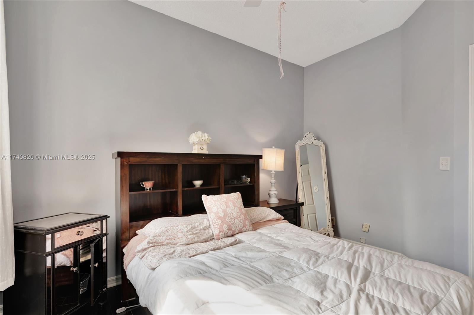 112 Lighthouse Circle, Unit H Tequesta, FL 33469 - Photo 19 of 39 a bedroom with a bed and a dresser