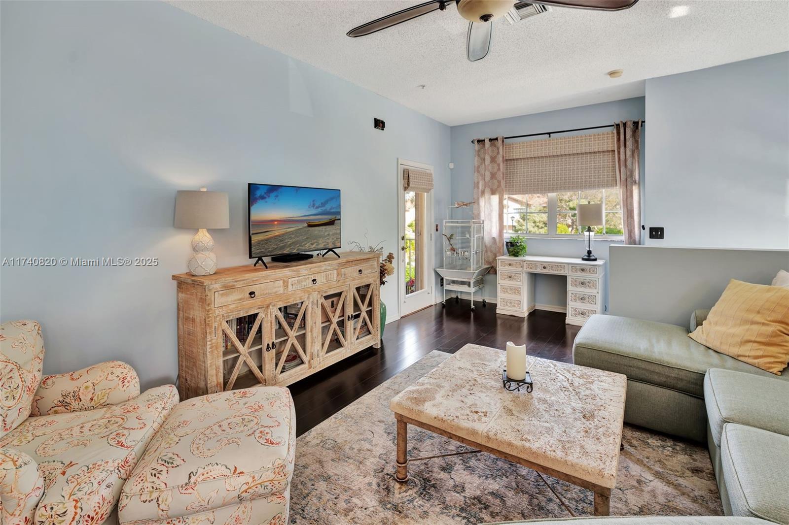 112 Lighthouse Circle, Unit H Tequesta, FL 33469 - Photo 7 of 39 a living room with furniture and a flat screen tv