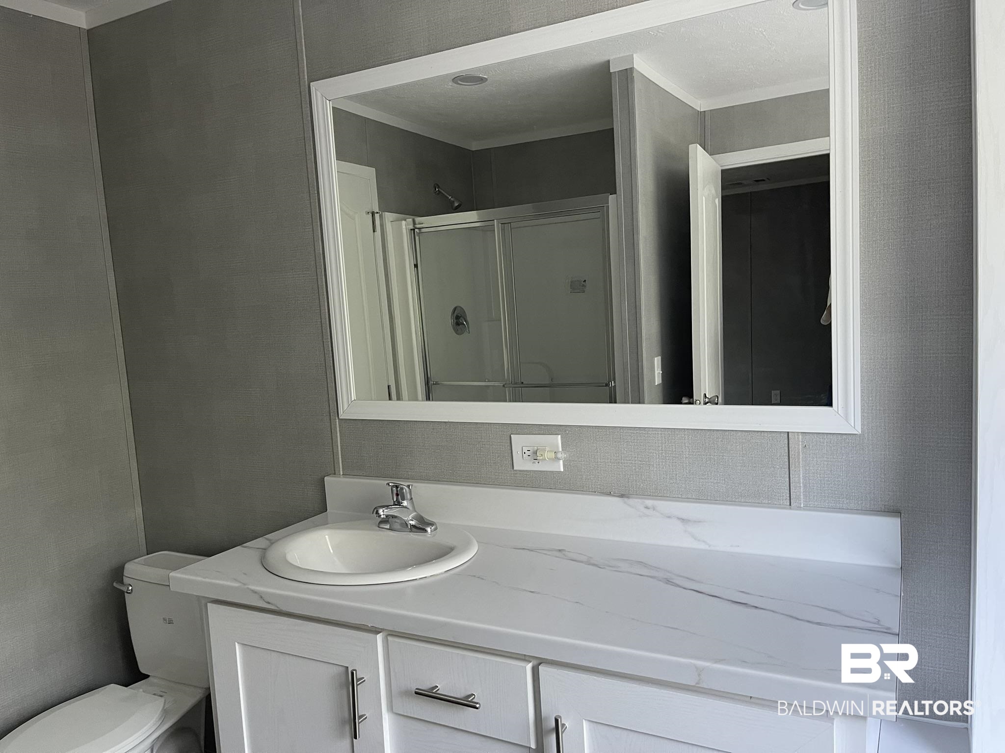 9202 Bay Pnes Road Elberta, AL 36530 - Photo 8 of 17 Bathroom featuring vanity, a shower stall, and ornamental molding