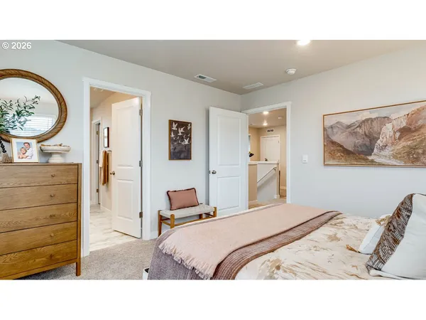 a bedroom with a bed and a dresser