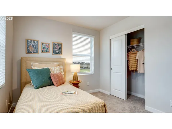 a bedroom with a bed and a painting