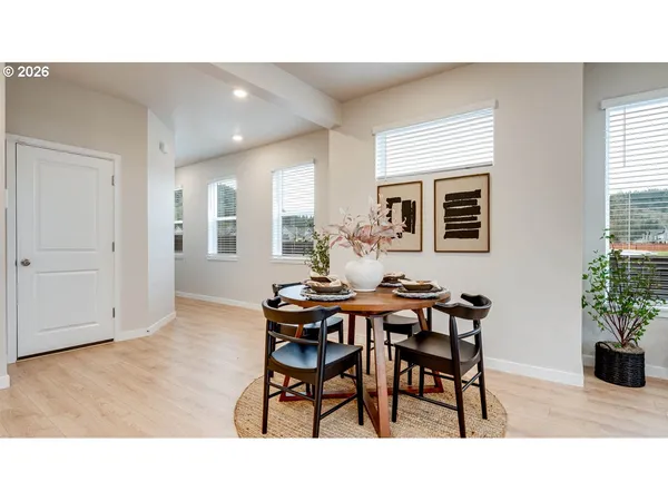 a dining room with furniture and window