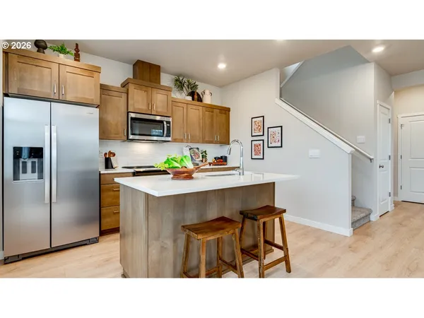 a kitchen with stainless steel appliances a refrigerator and a microwave