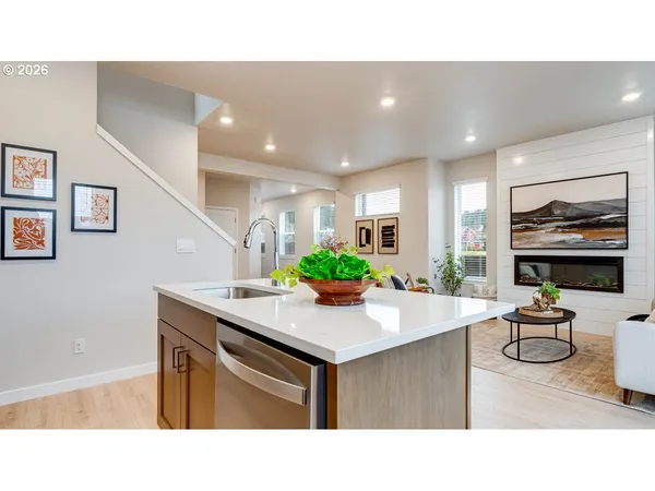a kitchen with kitchen island stainless steel appliances a sink and counter space