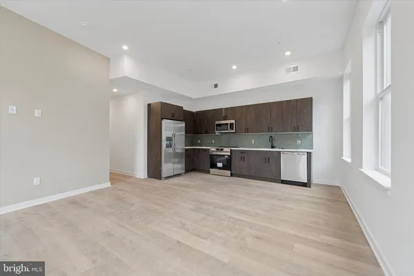 a view of a kitchen with a sink and a refrigerator