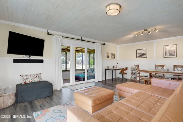 a bedroom with a bed and a flat tv screen on dresser