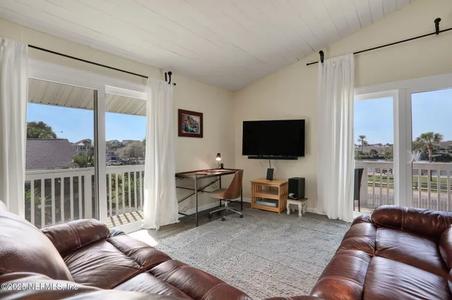 a front view of a house with a garden and plants