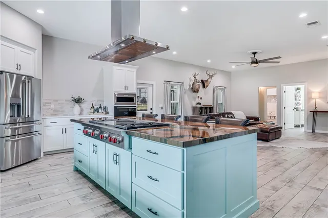 a kitchen with stainless steel appliances a stove sink and cabinets