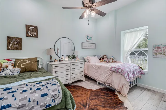 a bed room with two bed and a chair