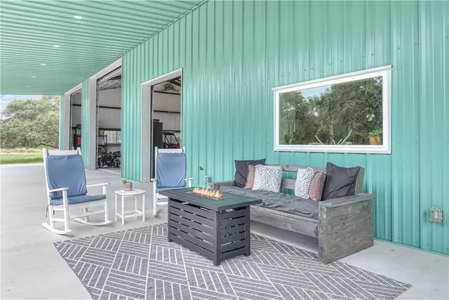 a outdoor living space with furniture and large window