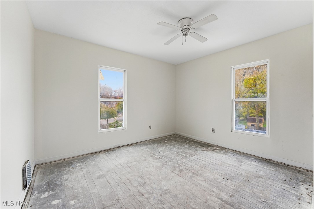 1206 Diagonal Road Akron, OH 44320 - Photo 23 of 28 Unfurnished room featuring wood-type flooring, plenty of natural light, and a ceiling fan