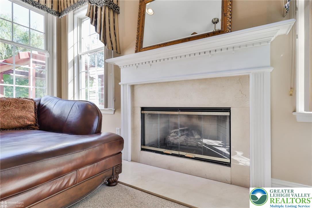 1991 Autumn Ridge Road Lower Macungie Township, PA 18062 - Photo 20 of 71 a living room with a couch and a fireplace