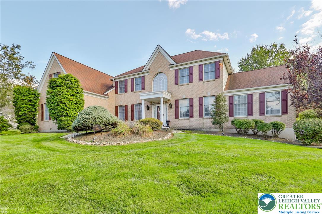 1991 Autumn Ridge Road Lower Macungie Township, PA 18062 - Photo 2 of 71 a front view of a house with a yard