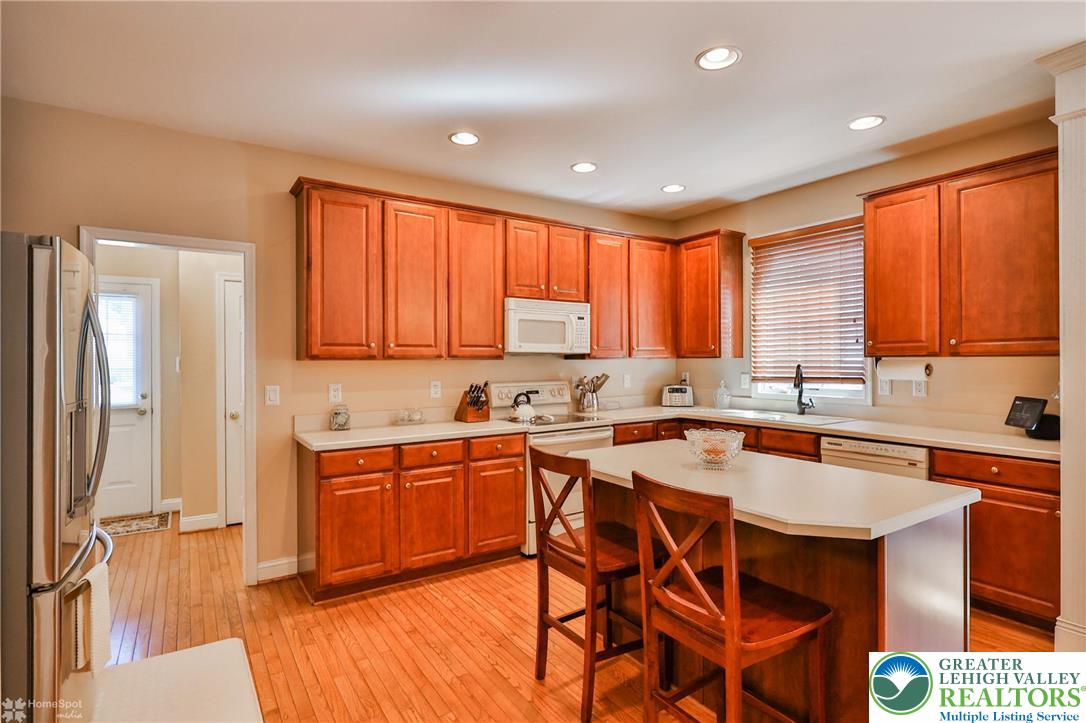 1991 Autumn Ridge Road Lower Macungie Township, PA 18062 - Photo 25 of 71 a kitchen with stainless steel appliances granite countertop wooden cabinets a sink and a stove