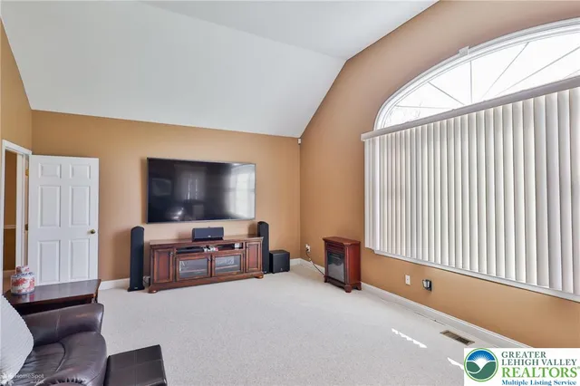 a bedroom with a bed and a television in it