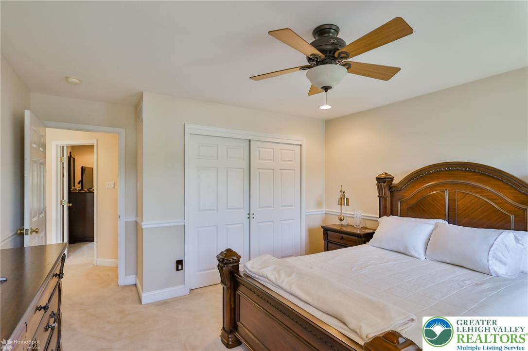 1991 Autumn Ridge Road Lower Macungie Township, PA 18062 - Photo 39 of 71 a bedroom with a bed and ceiling fan