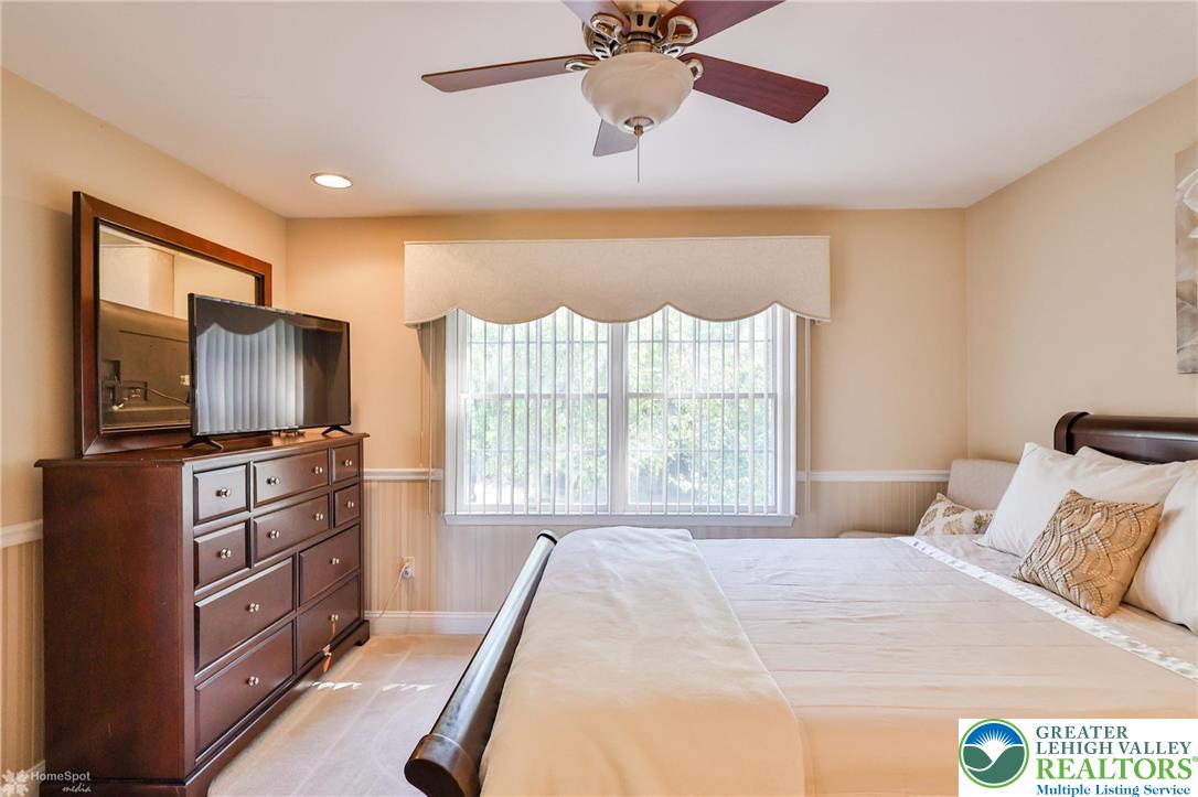 1991 Autumn Ridge Road Lower Macungie Township, PA 18062 - Photo 42 of 71 a bedroom with a bed and a flat screen tv
