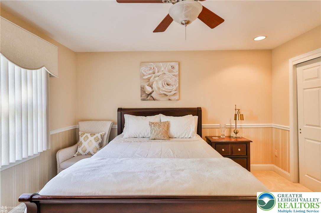 1991 Autumn Ridge Road Lower Macungie Township, PA 18062 - Photo 43 of 71 a bedroom with a large bed and a chandelier