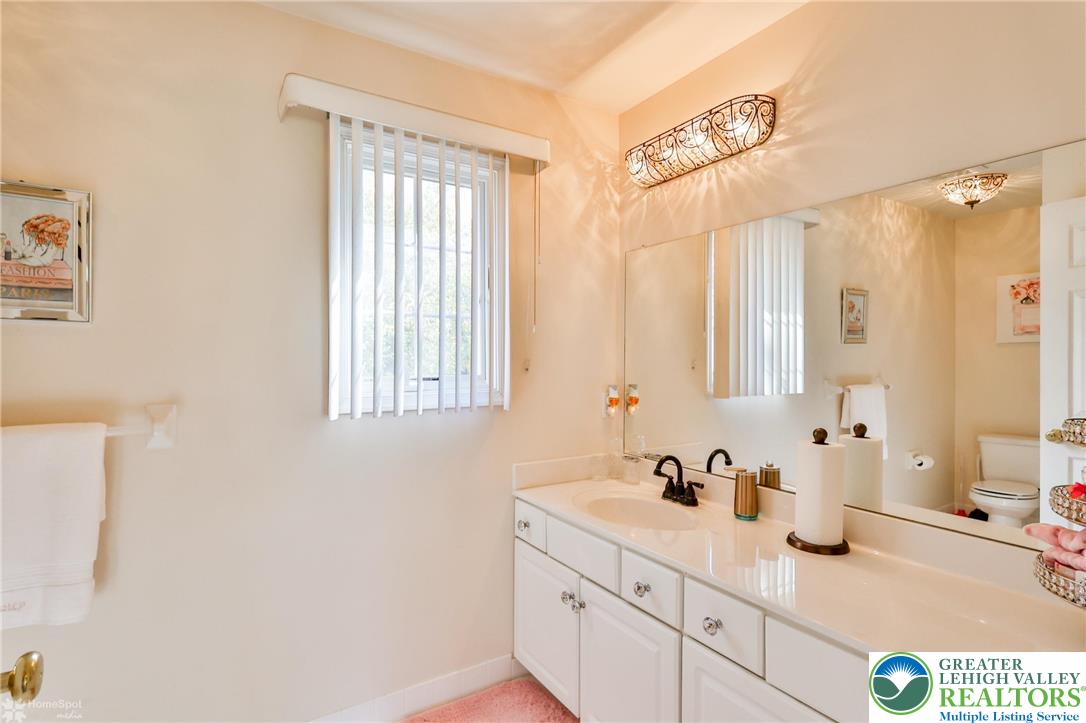 1991 Autumn Ridge Road Lower Macungie Township, PA 18062 - Photo 44 of 71 a bathroom with a granite countertop sink and a mirror