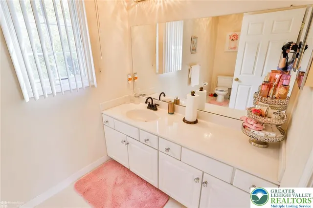 a spacious bedroom with a bed and a chandelier