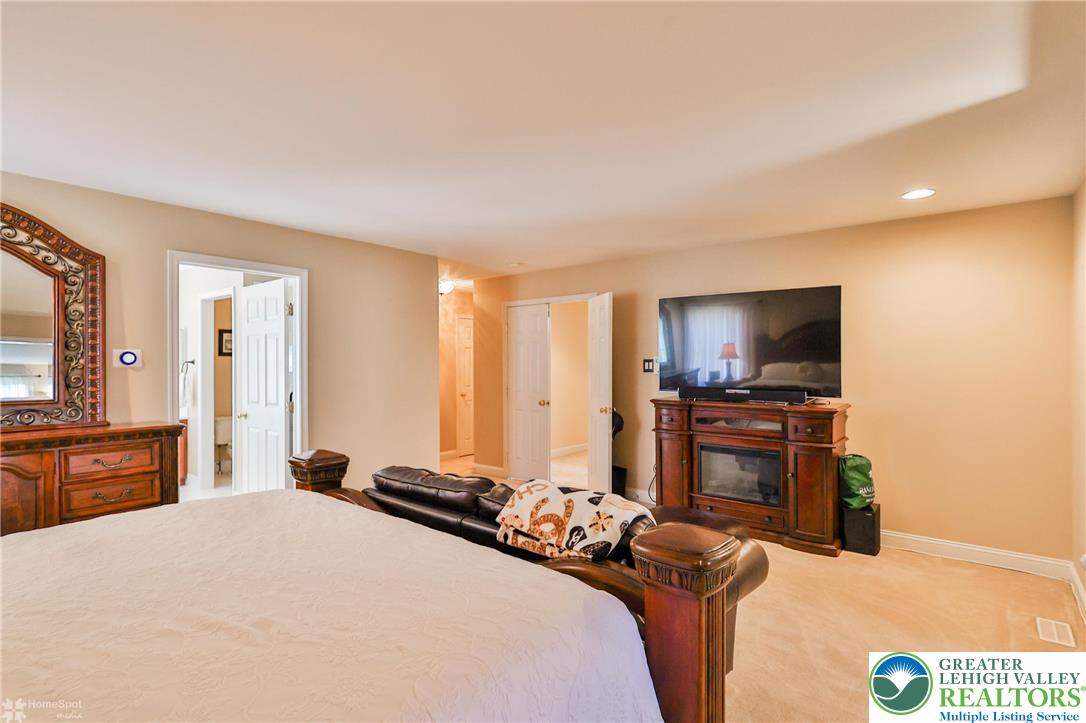 1991 Autumn Ridge Road Lower Macungie Township, PA 18062 - Photo 54 of 71 a bedroom with a bed and a flat screen tv