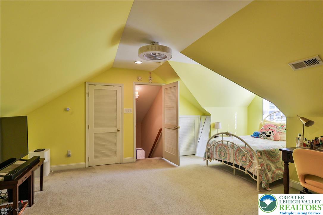 1991 Autumn Ridge Road Lower Macungie Township, PA 18062 - Photo 64 of 71 a spacious bedroom with a bed and a chandelier