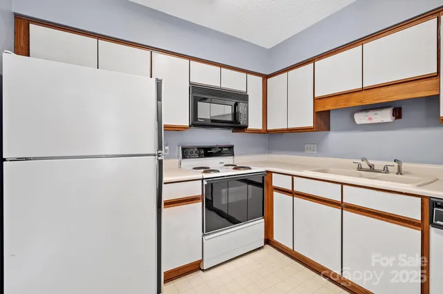 a kitchen with stainless steel appliances a refrigerator sink and microwave