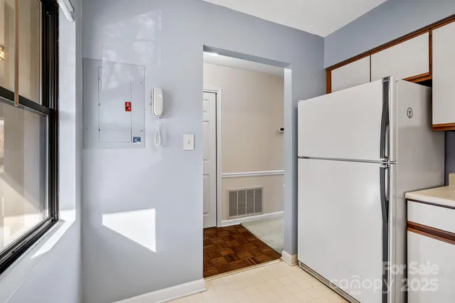 a white refrigerator freezer and a stove sitting inside of a kitchen