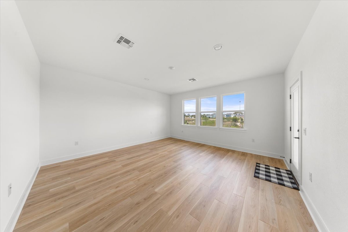 8700 Olmsted Way Austin, TX 78744 - Photo 32 of 40 Spare room featuring light wood finished floors and recessed lighting
