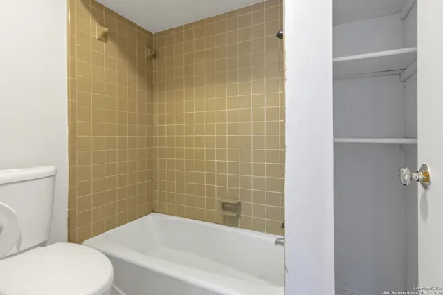 a bathroom with a bathtub and toilet