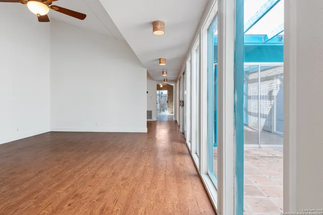 a view of a hallway with wooden floor