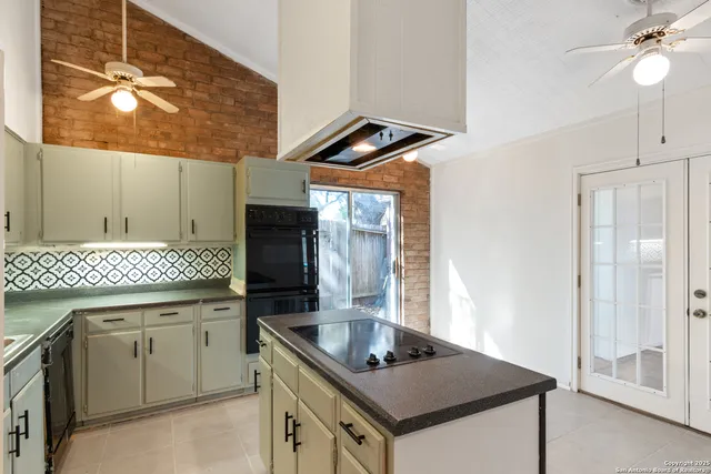 a kitchen with a sink a stove and cabinets