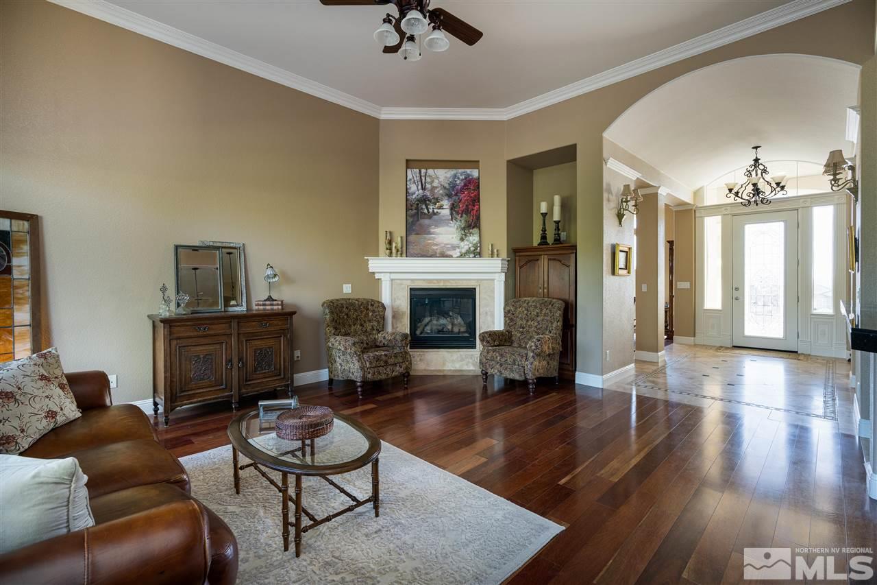 905 Peacepipe Loop Reno, NV 89511 - Photo 8 of 40 a living room with furniture and a fireplace