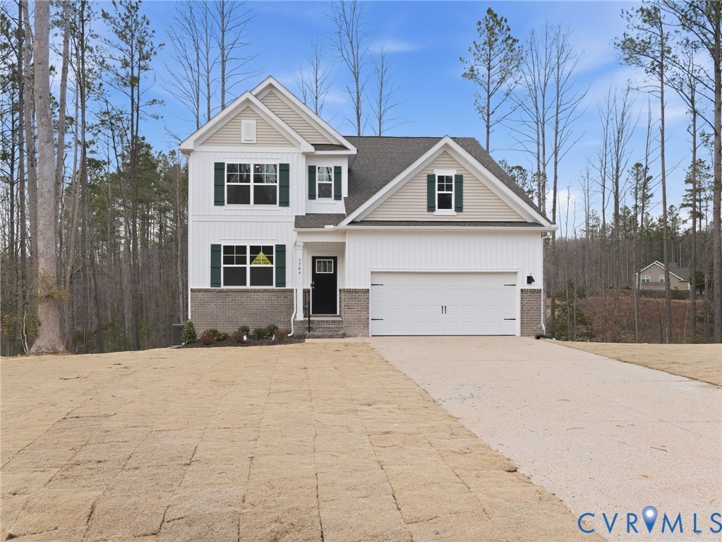 7784 Patriots Way Gloucester, VA 23061 - Photo 1 of 32 a front view of a house with a yard and garage