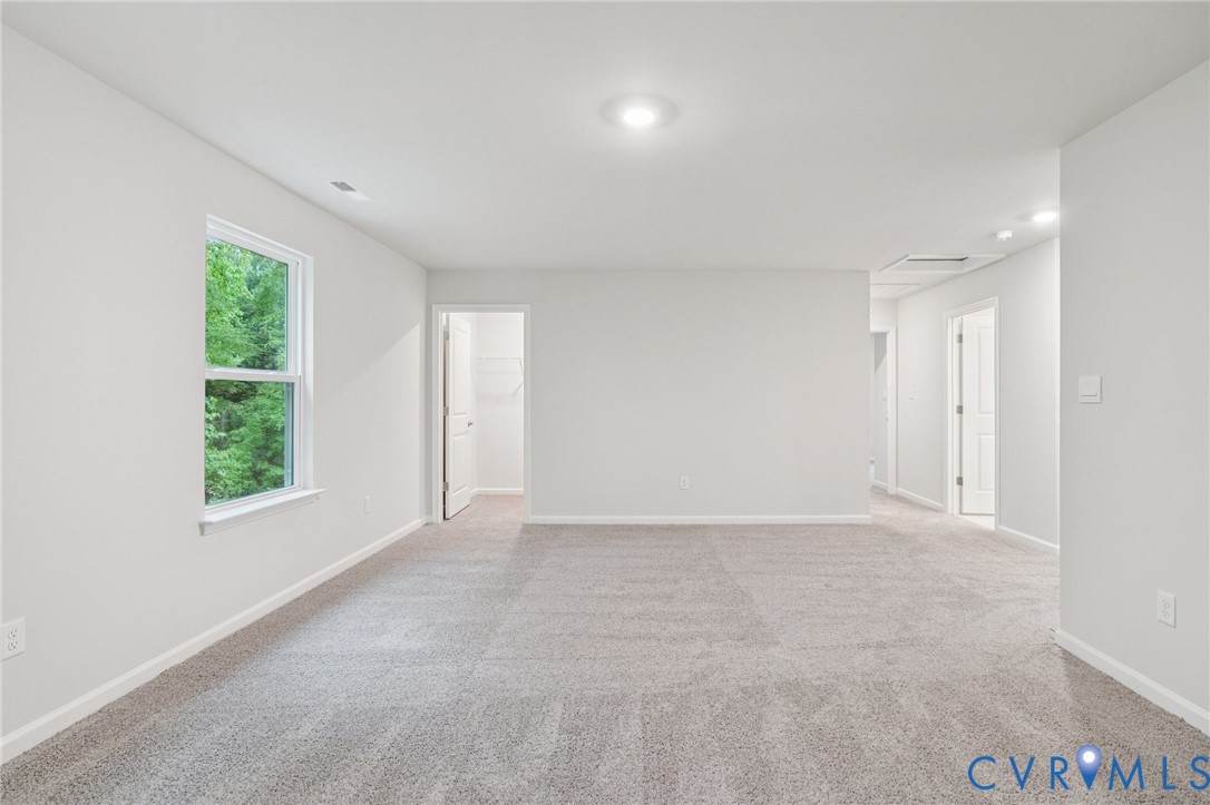 7784 Patriots Way Gloucester, VA 23061 - Photo 14 of 32 an empty room with windows and closet