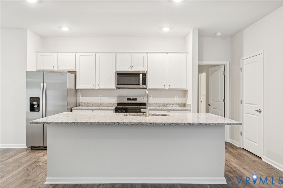 7784 Patriots Way Gloucester, VA 23061 - Photo 3 of 32 a kitchen with stainless steel appliances a refrigerator sink stove microwave and cabinets