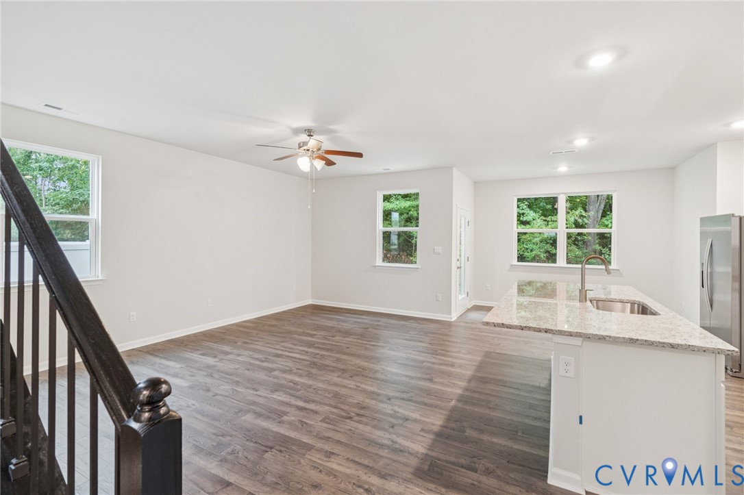 7784 Patriots Way Gloucester, VA 23061 - Photo 6 of 32 a view of an empty room with a window and wooden floor