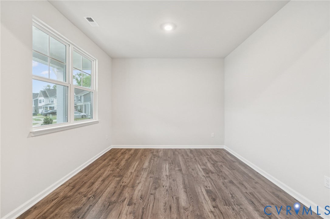7784 Patriots Way Gloucester, VA 23061 - Photo 8 of 32 a view of a room with wooden floor and windows