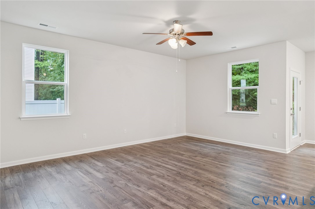 7784 Patriots Way Gloucester, VA 23061 - Photo 10 of 32 a view of an empty room with wooden floor and a window