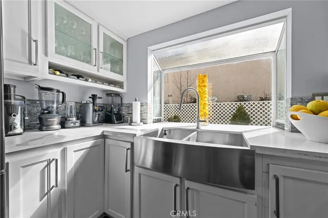 a kitchen with sink cabinets and appliances