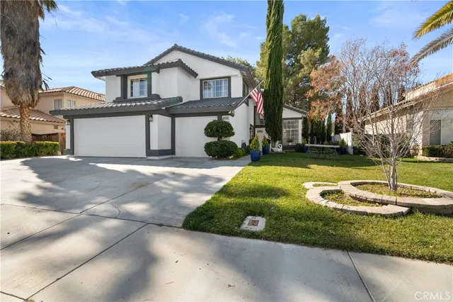 a front view of a house with a yard garage and outdoor seating