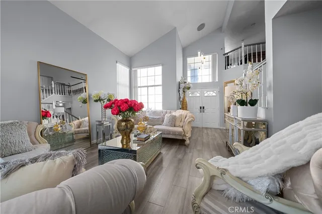 a living room with furniture and flowers
