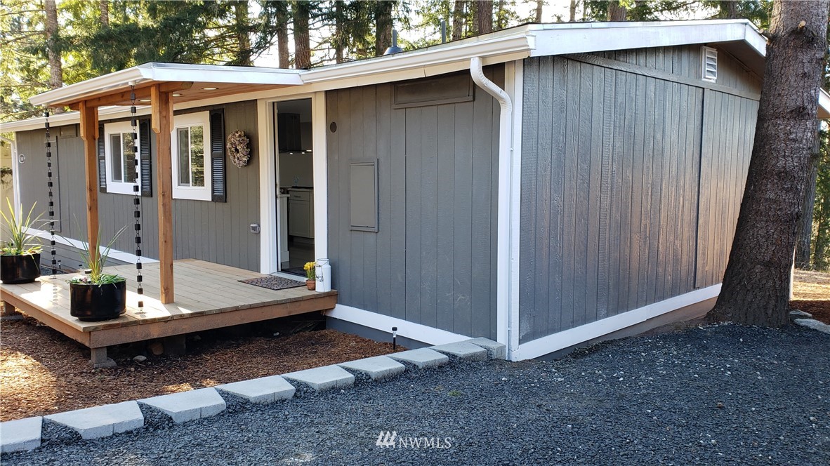 a view of backyard of house with car parked