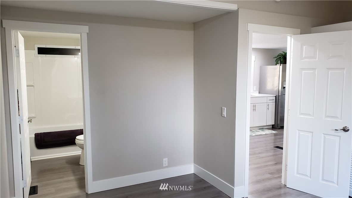 1040 Northeast Larson Boulevard Belfair, WA 98528 - Photo 14 of 31 a view of a bathroom with a walk in closet and wooden floor