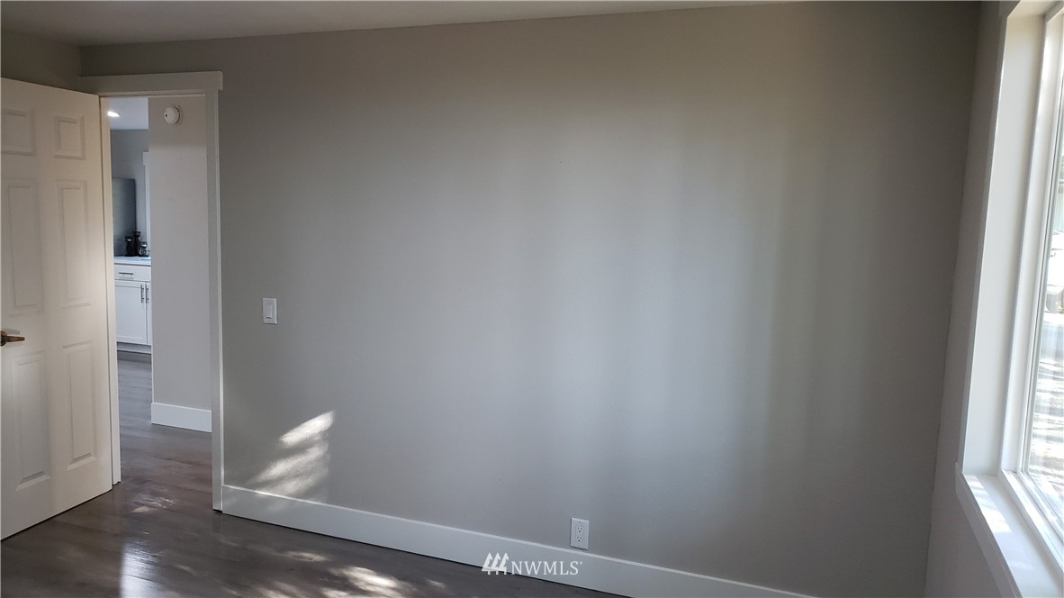 1040 Northeast Larson Boulevard Belfair, WA 98528 - Photo 18 of 31 an empty room with wooden floor and windows
