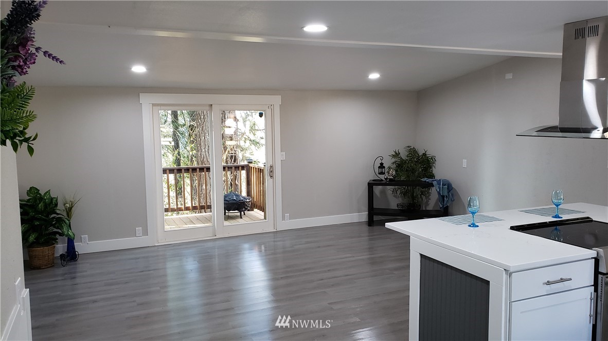 1040 Northeast Larson Boulevard Belfair, WA 98528 - Photo 23 of 31 a kitchen with a sink and wooden floor